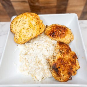 Grilled chicken with garlic bread and creamy mashed potatoes, classic Italian cooking ideas and recipes.