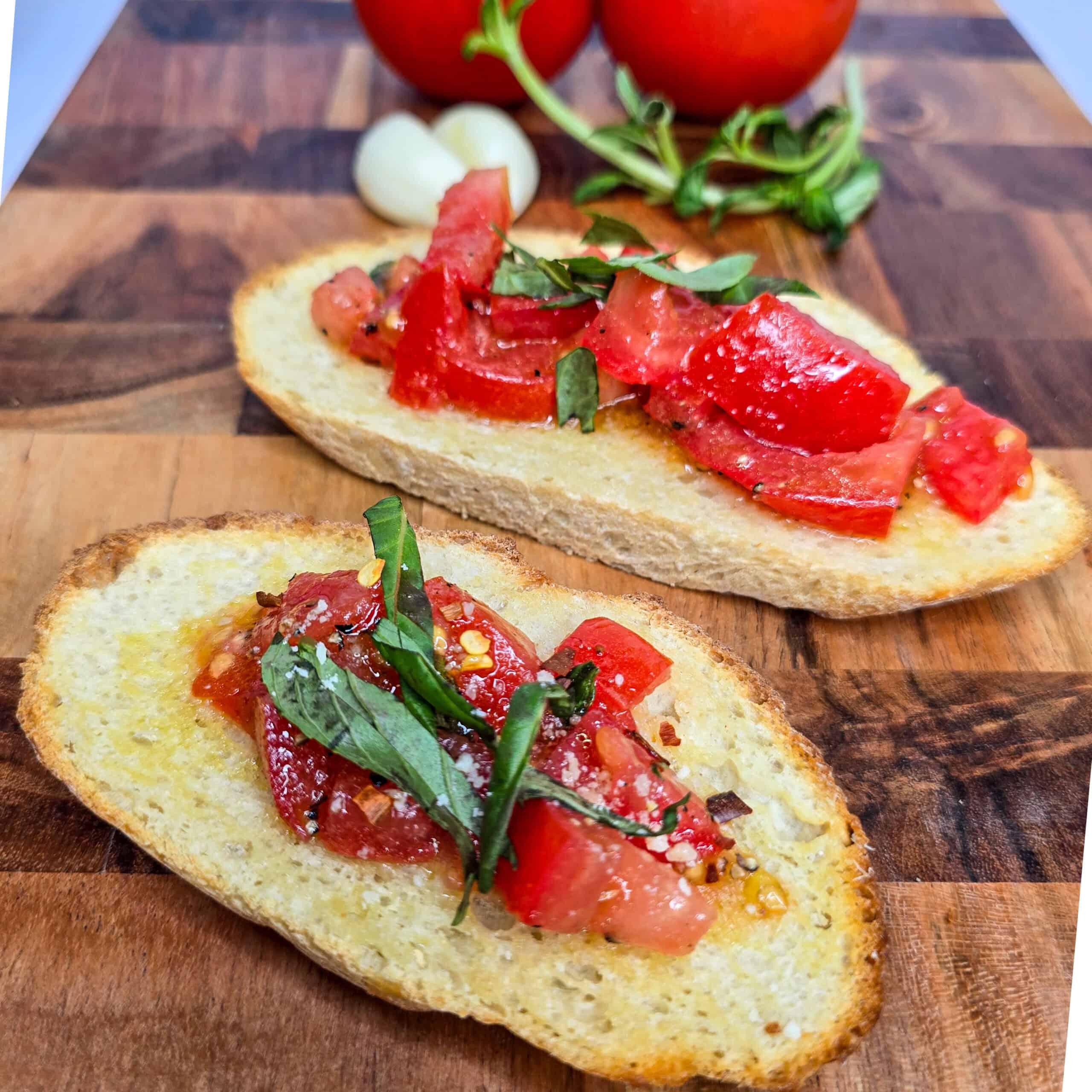 Roasted tomato bruschetta on toasted Italian bread with fresh basil and garlic.