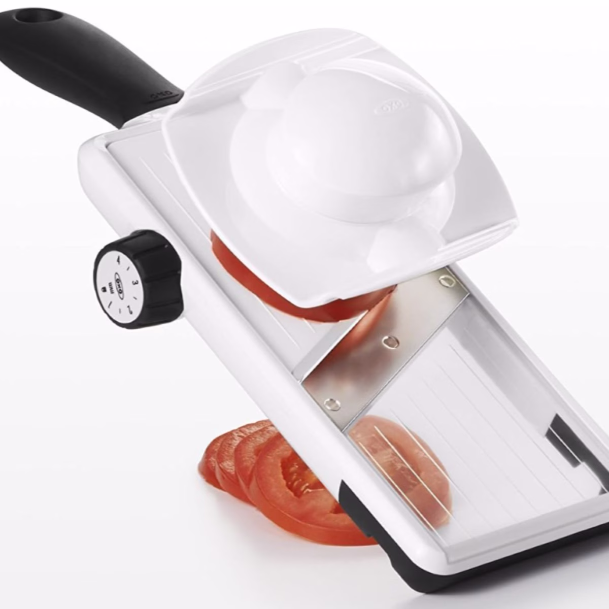 A slicer with a tomato on it