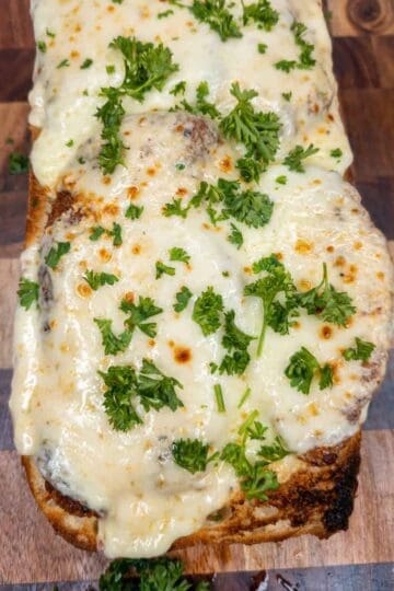 Chicken topped with melted cheese and fresh herbs, perfect for Italian cooking recipes.