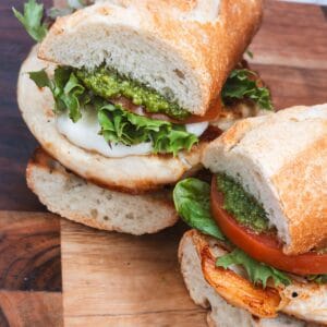 Fresh Italian sandwich with pesto, tomatoes, and basil on crusty bread. Perfect for Italian cooking ideas and recipes.