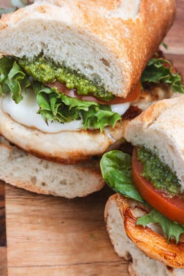 Fresh Italian sandwich with pesto, tomatoes, and basil on crusty bread. Perfect for Italian cooking ideas and recipes.