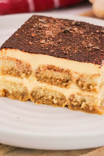 Rich Italian tiramisu dessert recipe with coffee-soaked ladyfingers and mascarpone cheese, topped with cocoa powder.