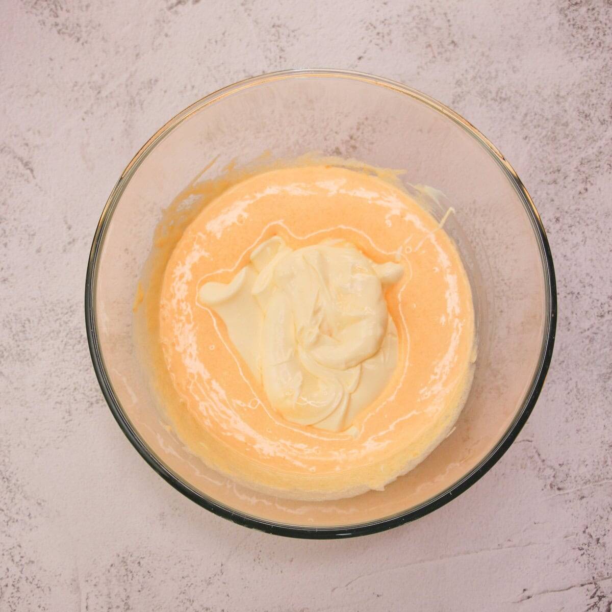 Creamy zabaglione and mascarpone mixture for Italian tiramisu recipe in a glass bowl.