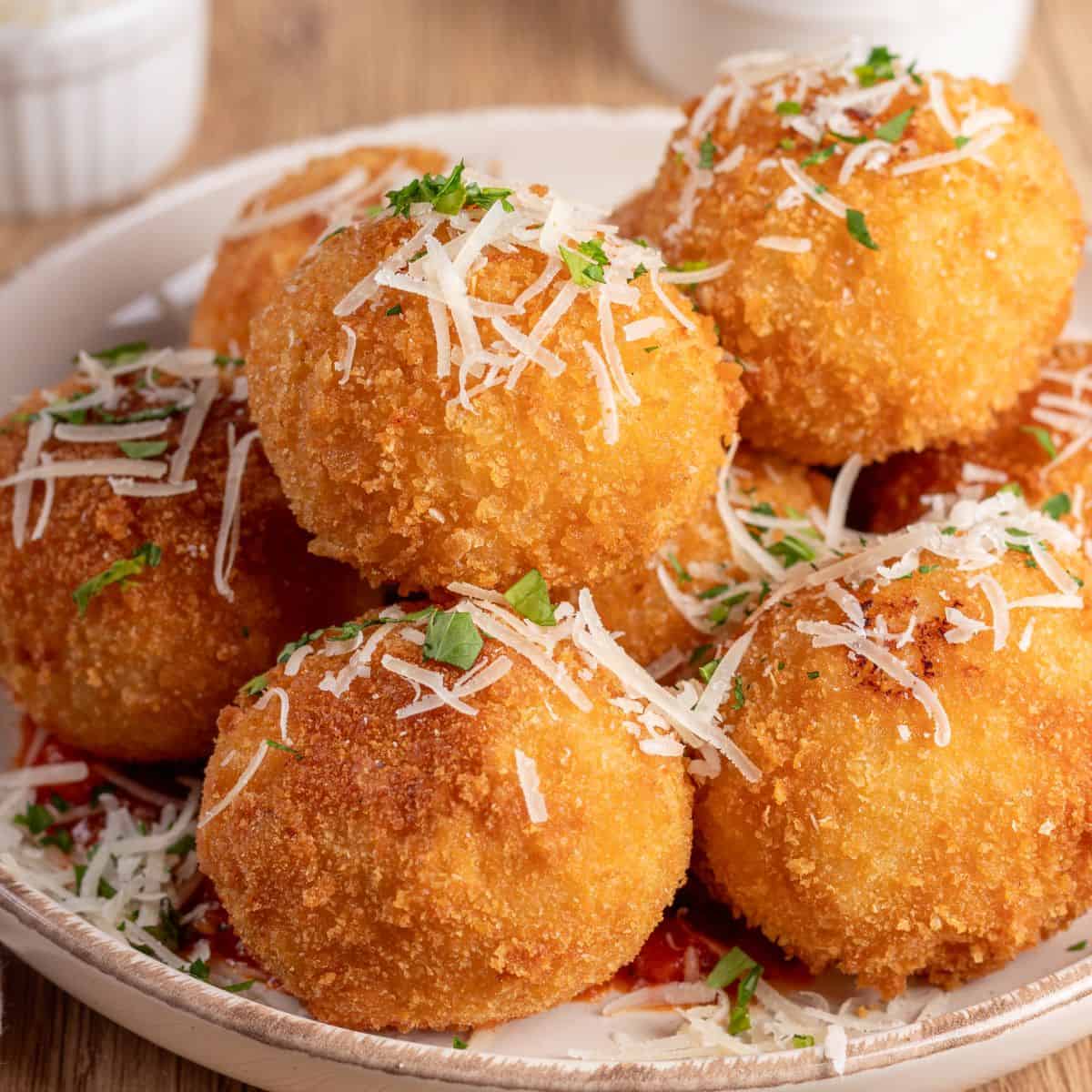 Delicious Italian Arancini topped with cheese and herbs, perfect for authentic Italian recipes.