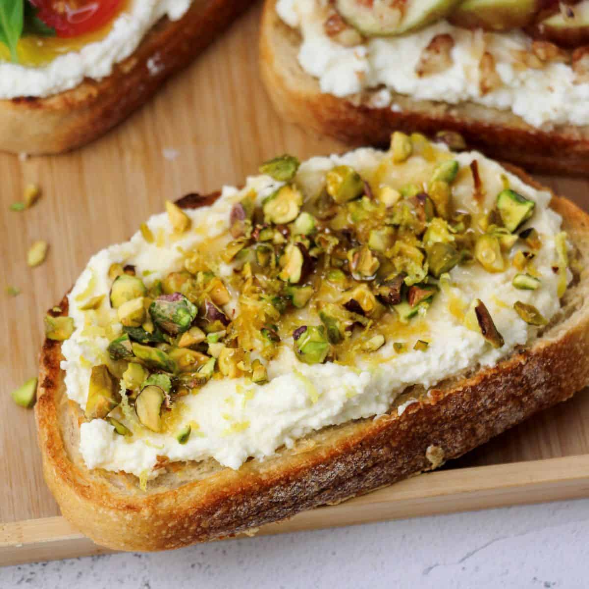 Delicious toasted bread topped with creamy cheese and Honey, Pistachio & Lemon Zest, perfect for Italian cooking ideas.