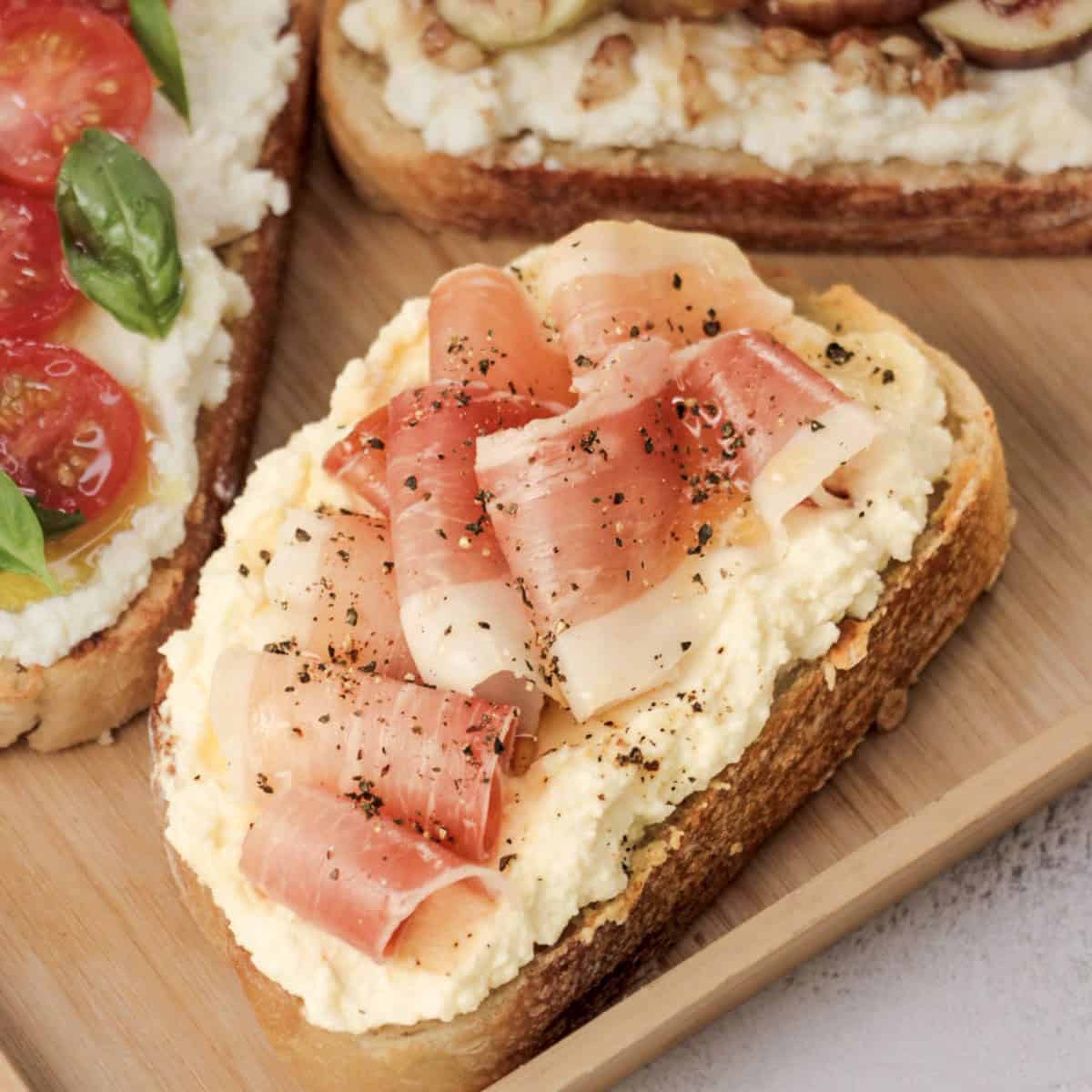 Delicious Italian-style toast topped with creamy ricotta, crispy prosciutto, and cracked black pepper.