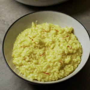 Risotto alla Milanese in a white bowl, perfect for authentic Italian cooking ideas and recipes.