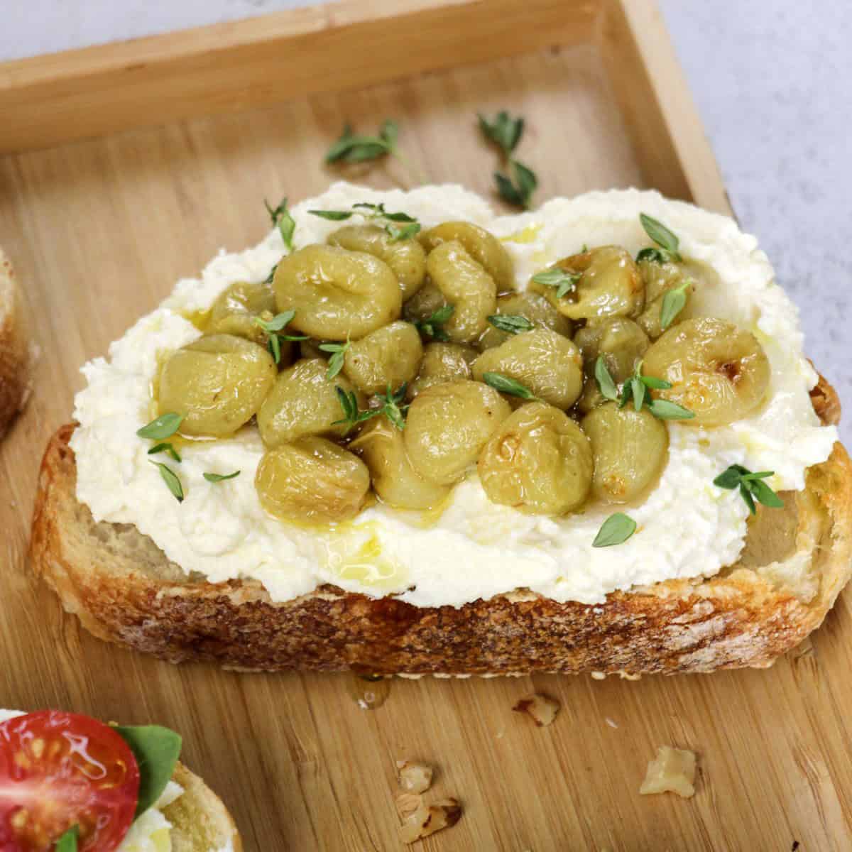 Delicious Italian crostini topped with fresh grapes, cream cheese, and herbs. Perfect for Italian cooking ideas and recipes.