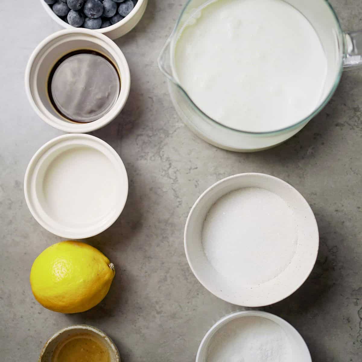 Fresh lemon, sugar, vanilla, and dairy ingredients for Italian cooking recipes.