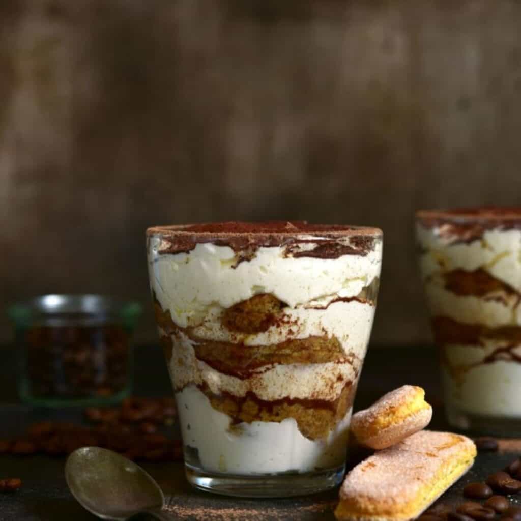 Delicious homemade dolce tiramisu served in a glass with coffee-soaked ladyfingers and mascarpone cheese.