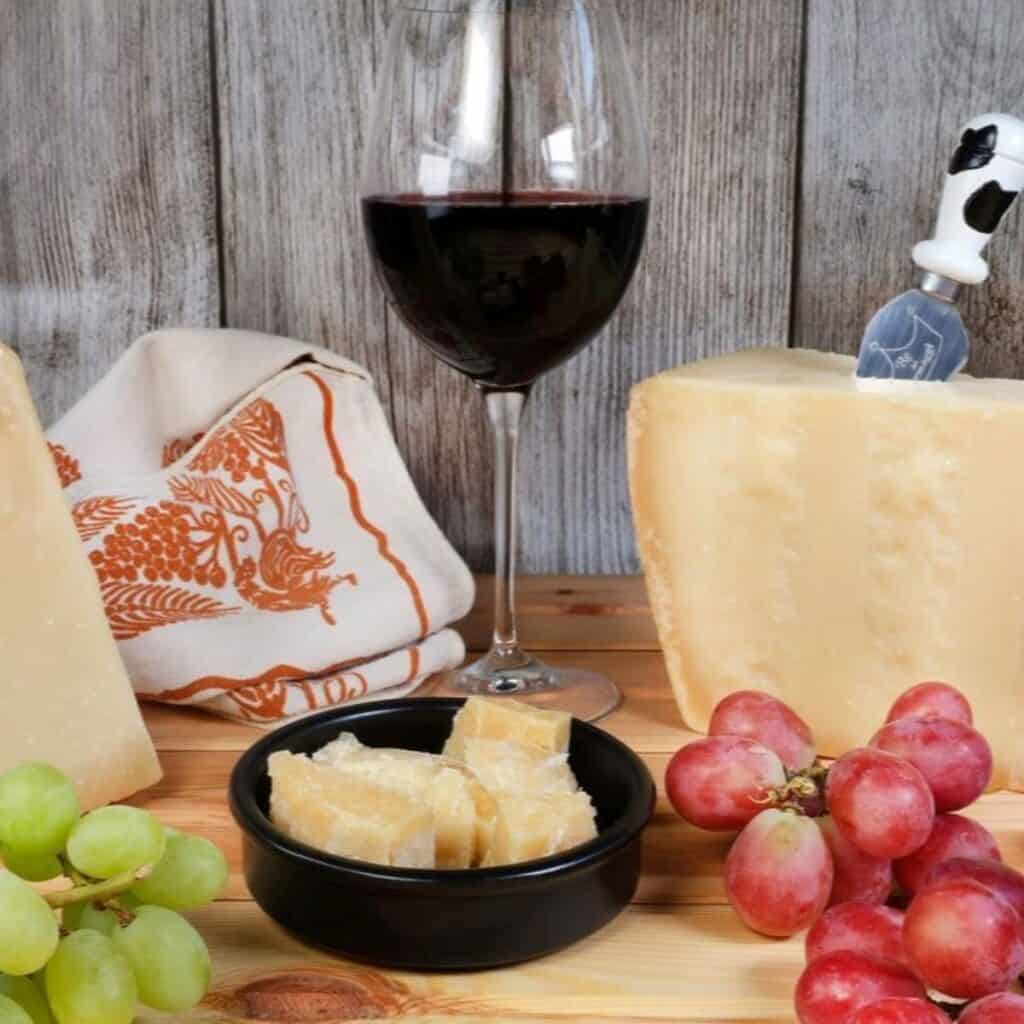 Traditional Italian Formaggi e Frutta cheese with a glass of red wine and fresh grapes.