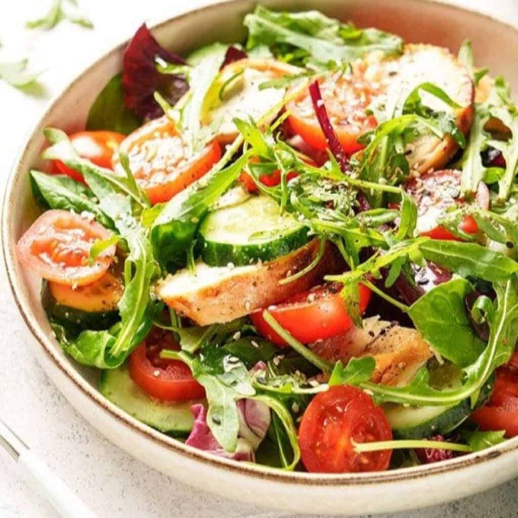 Colorful Italian insalata salad with cherry tomatoes, cucumbers, and mixed greens.