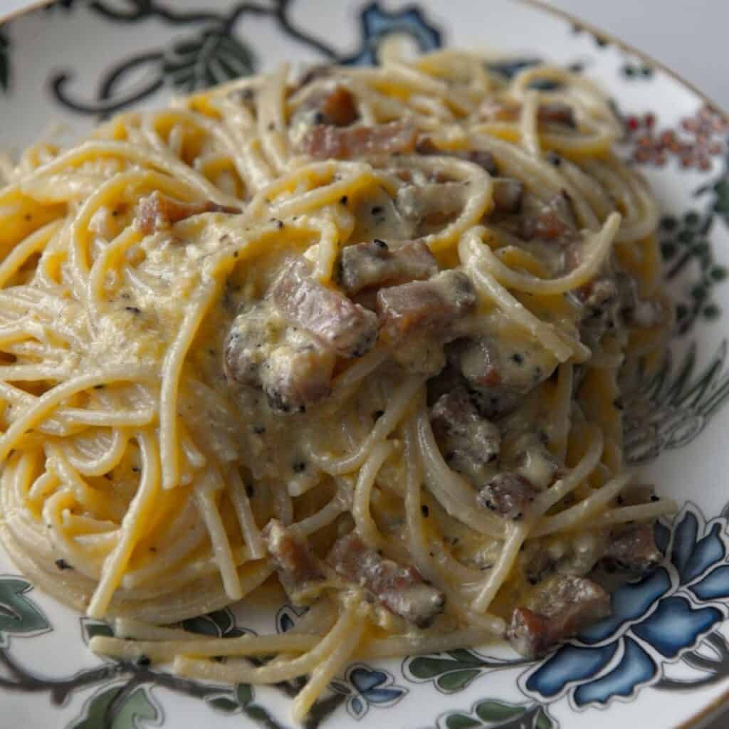 Classic Italian primo Carbonara pasta with creamy sauce and pancetta, perfect for authentic Italian cookin.